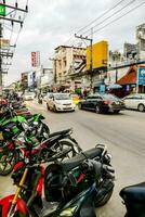 motorcycles parked on the side of a busy street photo