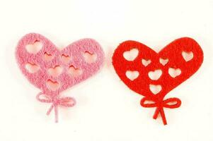 two felt heart shapes on a white background photo