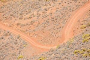 an aerial view of a dirt road in the desert photo