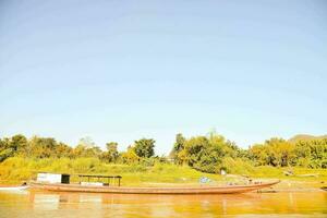 a boat on the mekong river in laos photo