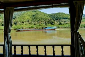 a view of a boat on the mekong river from a window photo