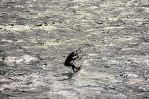 a person kiteboarding in the ocean photo