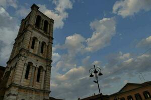 a tall tower against a cloudy blue sky photo