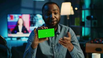 Content creator in studio films newly released chroma key smartphone video review for tech enthusiasts. Viral online star hosts technology internet show, unboxing isolated screen cellphone