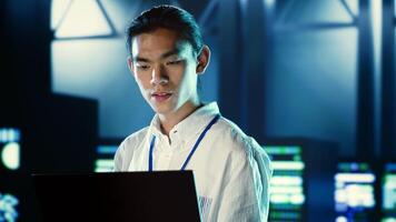 Skillful employee walking through data center systems providing processing resources for different workloads. Admin diagnosing server racks tasked with solving complex operations photo