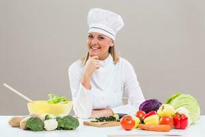 Portrait of female chef making healthy meal photo