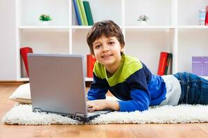 Little boy using laptop photo