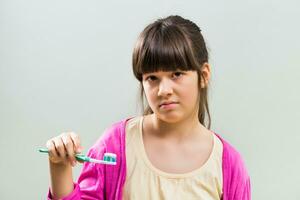 Little girl doesn't want to brush her teeth photo