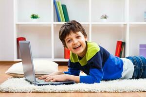 Little boy using laptop photo