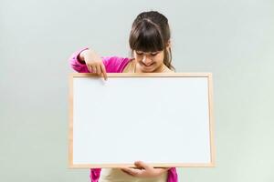 Little girl holding whiteboard photo