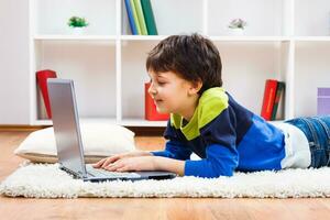 Little boy using laptop photo