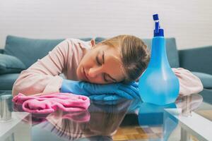 Overworked housewife feel asleep while cleaning house photo