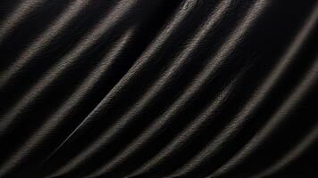 Heavy crumpled black paper texture in low light background. photo