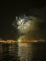 colorful fireworks in the night sky on the seafront of Alicante spain photo