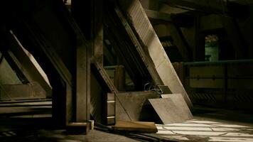 A dimly lit room with a striking metal structure in the center video