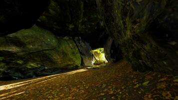 Empty road goes through the cave with glowing end video