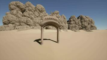 A small arch in the middle of a desert video