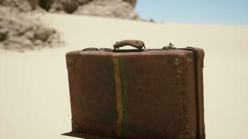 A piece of luggage sitting on top of a sandy beach video