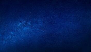 blank blue texture surface background with dark corners. blue grainy cement wall background with space for text. photo