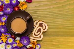 Image of cup of coffee, cookies and  beautiful flowers on wooden background photo