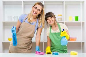 Happy mother and her daughter enjoy cleaning together. photo