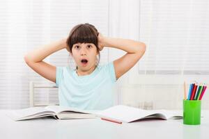 Little girl is in panic because of her homework photo