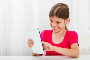 Little girl using digital tablet photo