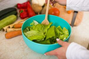 Close up photo of making salad in kitchen