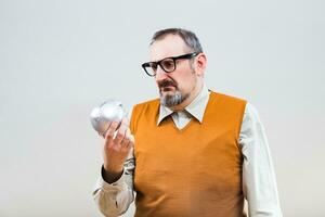 Nerdy man is worried because he is having problem with saving money photo