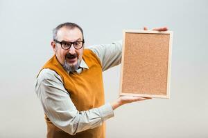 Nerdy businessman is showing empty cork board photo