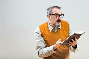 Nerdy businessman is holding his personal organizer and working photo