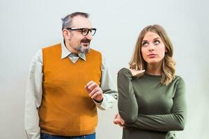 Nerdy man is trying to get beautiful woman's attention but she is not interested and angry ignore him photo