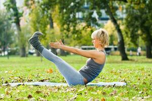 Beautiful woman exercising  yoga outdoor photo