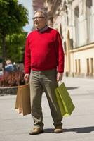 Senior man enjoys in shopping at the city photo