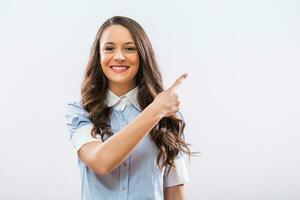 Image of beautiful businesswoman pointing on gray background photo