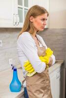 Housewife is angry because she is tired of cleaning and housework photo