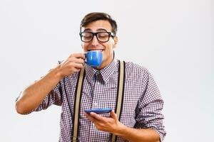 Nerdy man enjoys drinking coffee photo