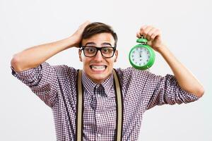 Nerdy man in panic holding clock photo