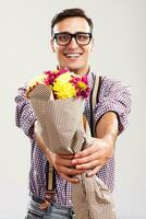Nerdy man is holding  bouquet of flowers photo