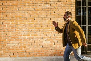 Modern businessman with beard  running in a hurry on the street photo