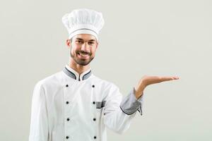 Chef gesturing on gray background. photo