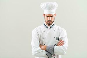 Angry chef on gray background. photo