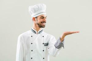 Chef gesturing on gray background photo