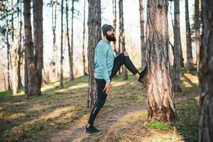 Man with beard enjoys exercising in nature photo