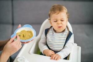 Angry baby boy doesn't want to eat photo