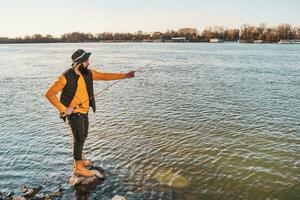 Man enjoys fishing at the river photo