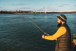 Man enjoys fishing at the river photo