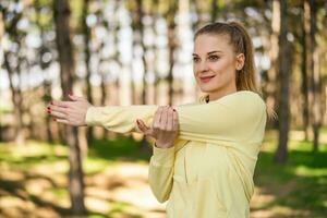 Woman enjoys exercising in the nature photo