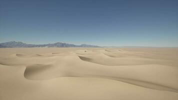 A wide expanse of sand with mountains in the distance video