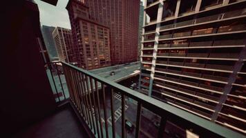 A cityscape captured from a balcony with a view of the bustling streets below video